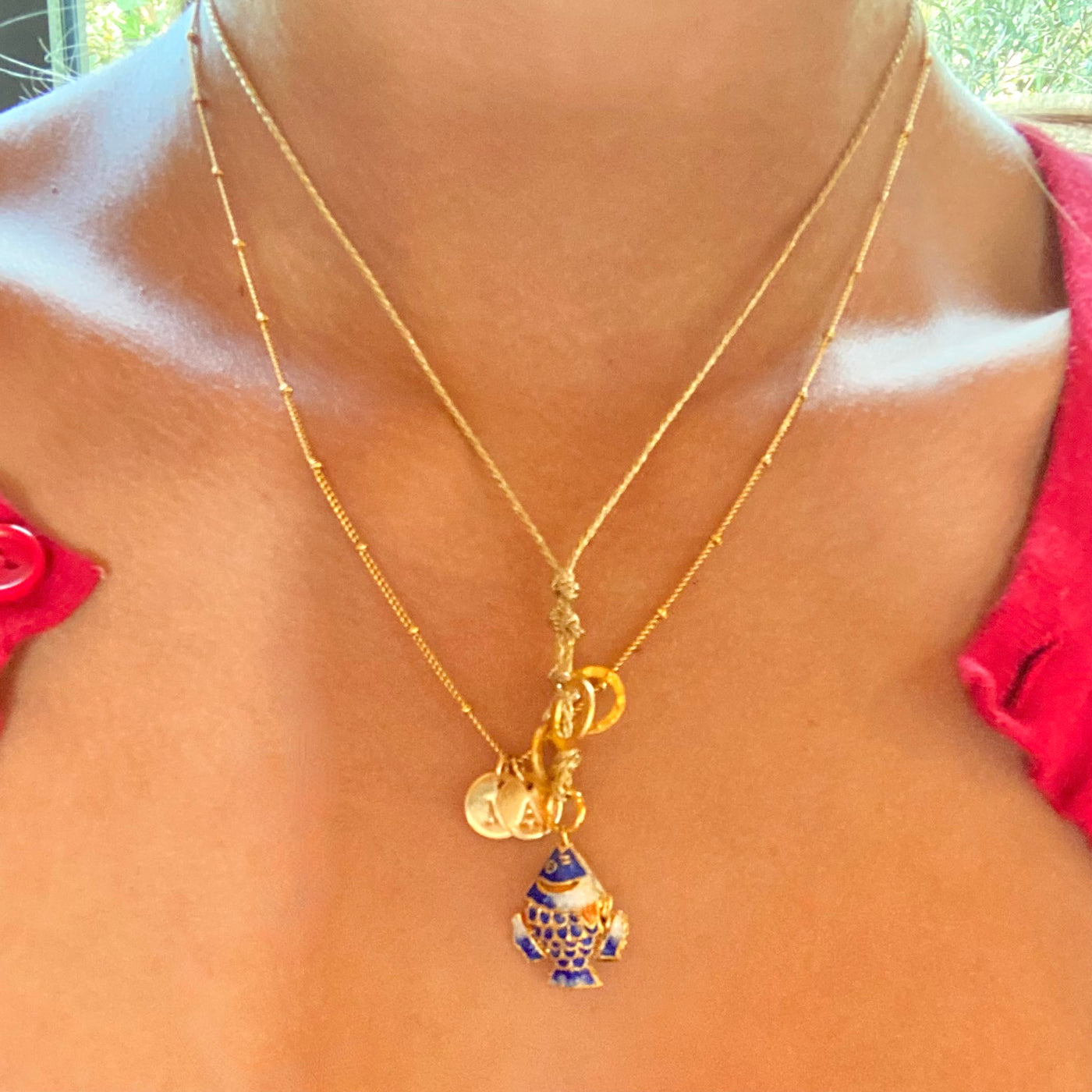 blue fish on a gold cord necklace